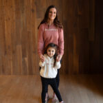 Mom and young daughter sharing a sweet moment during a spring lifestyle photo session.