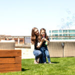 Mom and young daughter sharing a sweet moment during a spring lifestyle photo session.