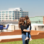 Mom and young daughter sharing a sweet moment during a spring lifestyle photo session.