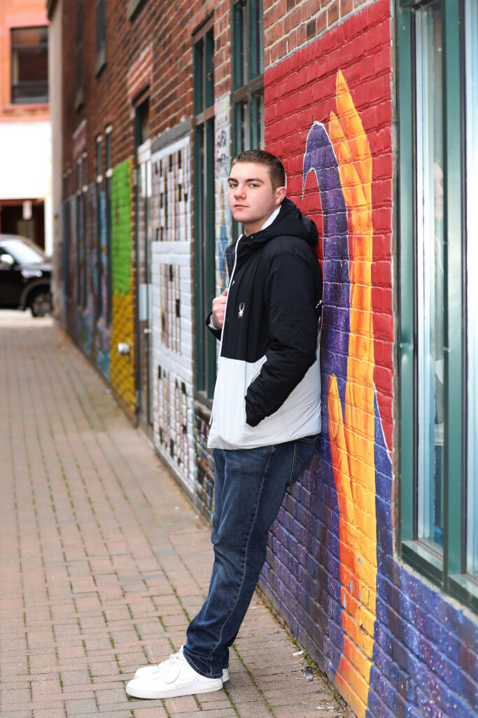 Senior photo at Artist’s Alley in La Crosse WI with Onalaska graffiti wall background