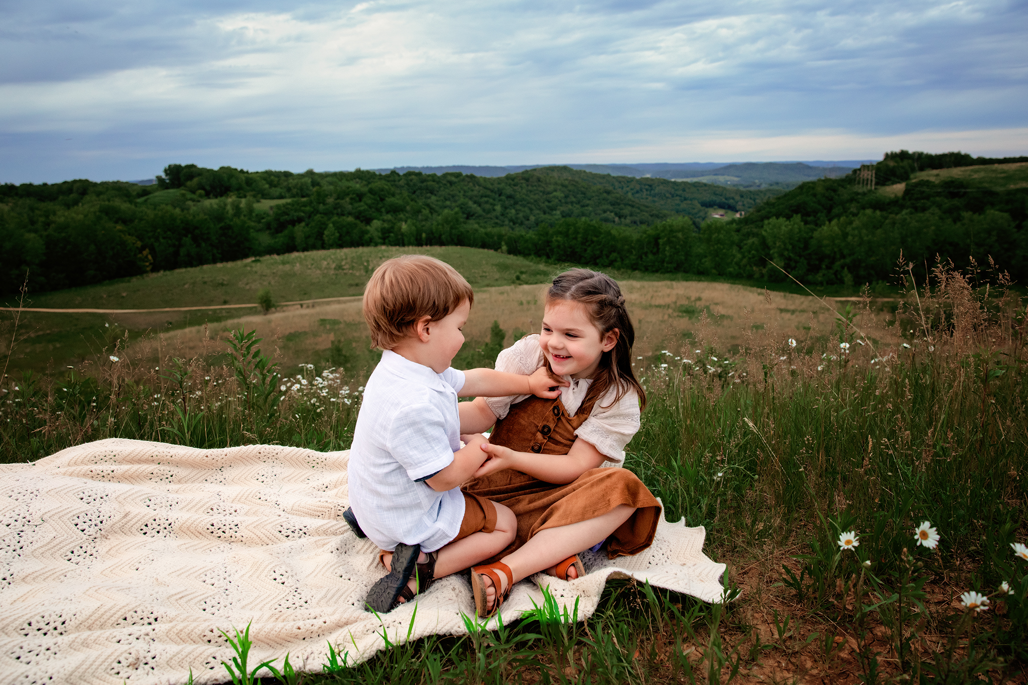 Relaxed lifestyle family photographer in Holmen Wisconsin capturing siblings interacting naturally outdoors