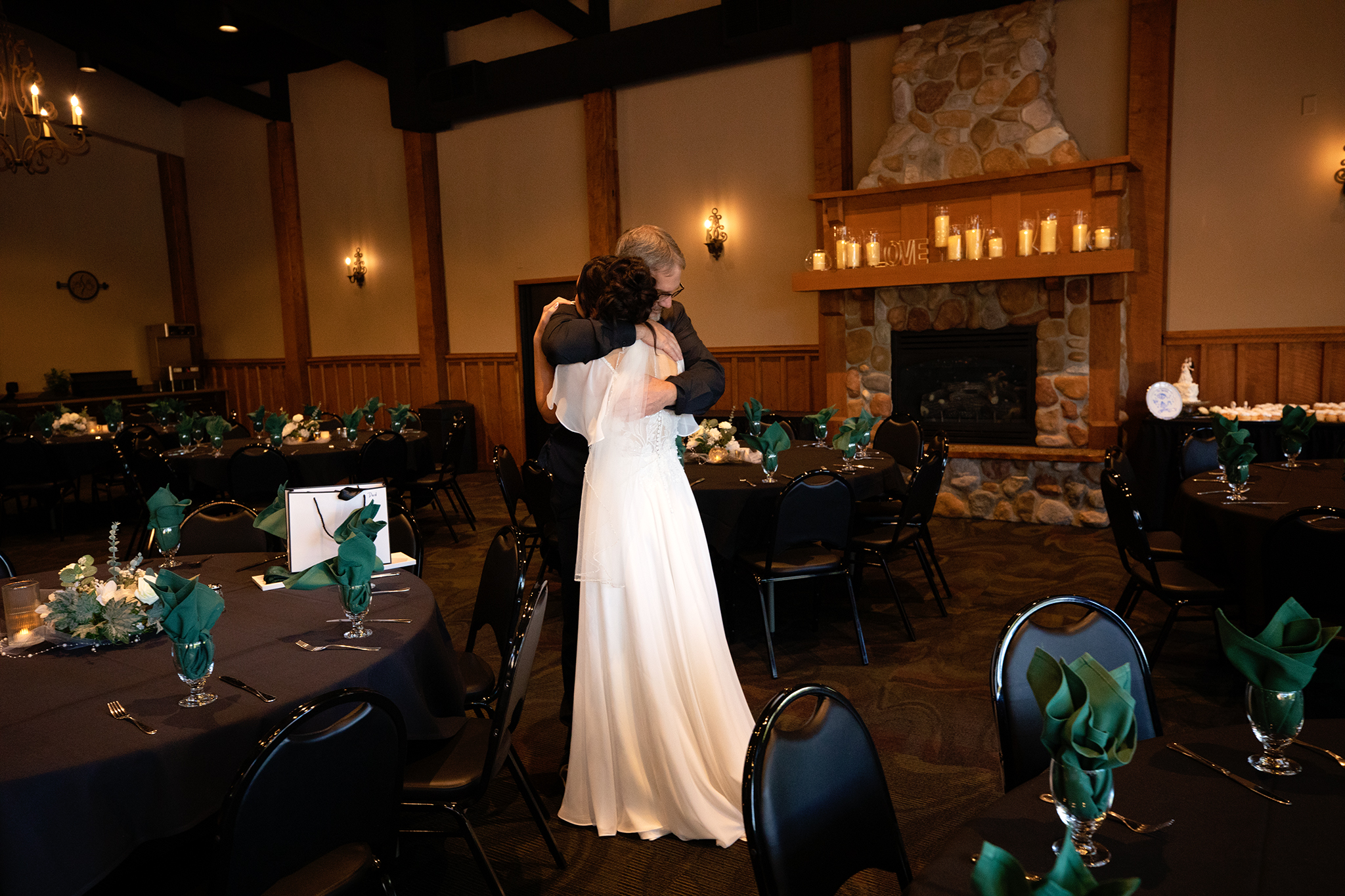 Candid wedding photography in Onalaska Wisconsin capturing a real emotional moment of a bride and father indoors with natural light