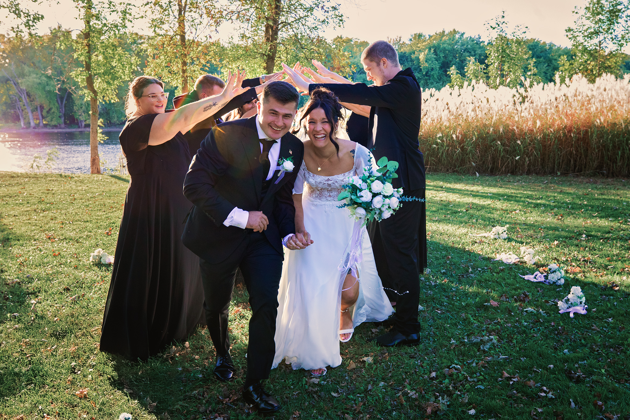 Documentary wedding photography in Holmen and Onalaska Wisconsin capturing a joyful outdoor wedding moment with bridal party