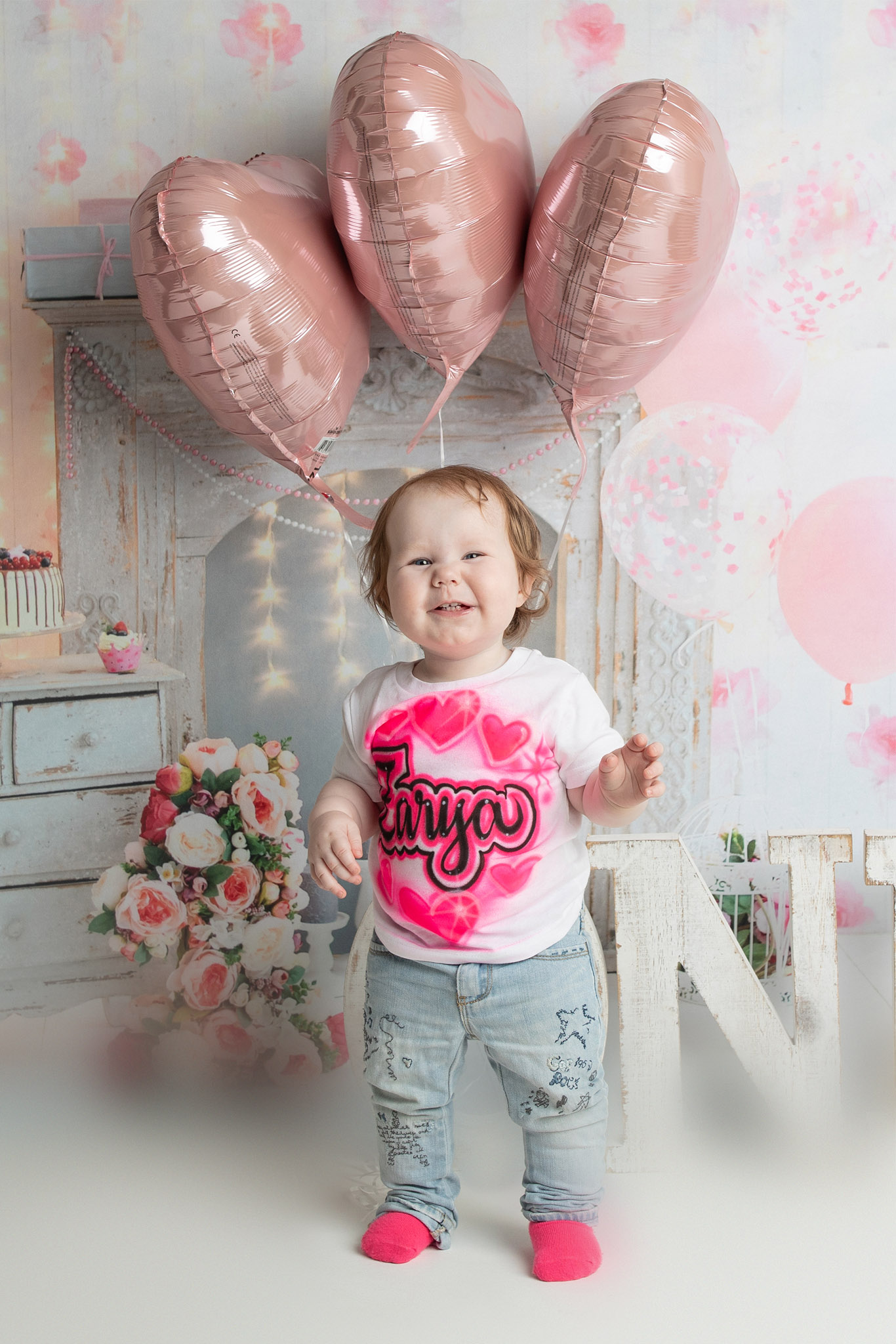First birthday cake smash session in Onalaska Wisconsin featuring a baby celebrating her first birthday in a styled studio setup by Visual Creations Photography