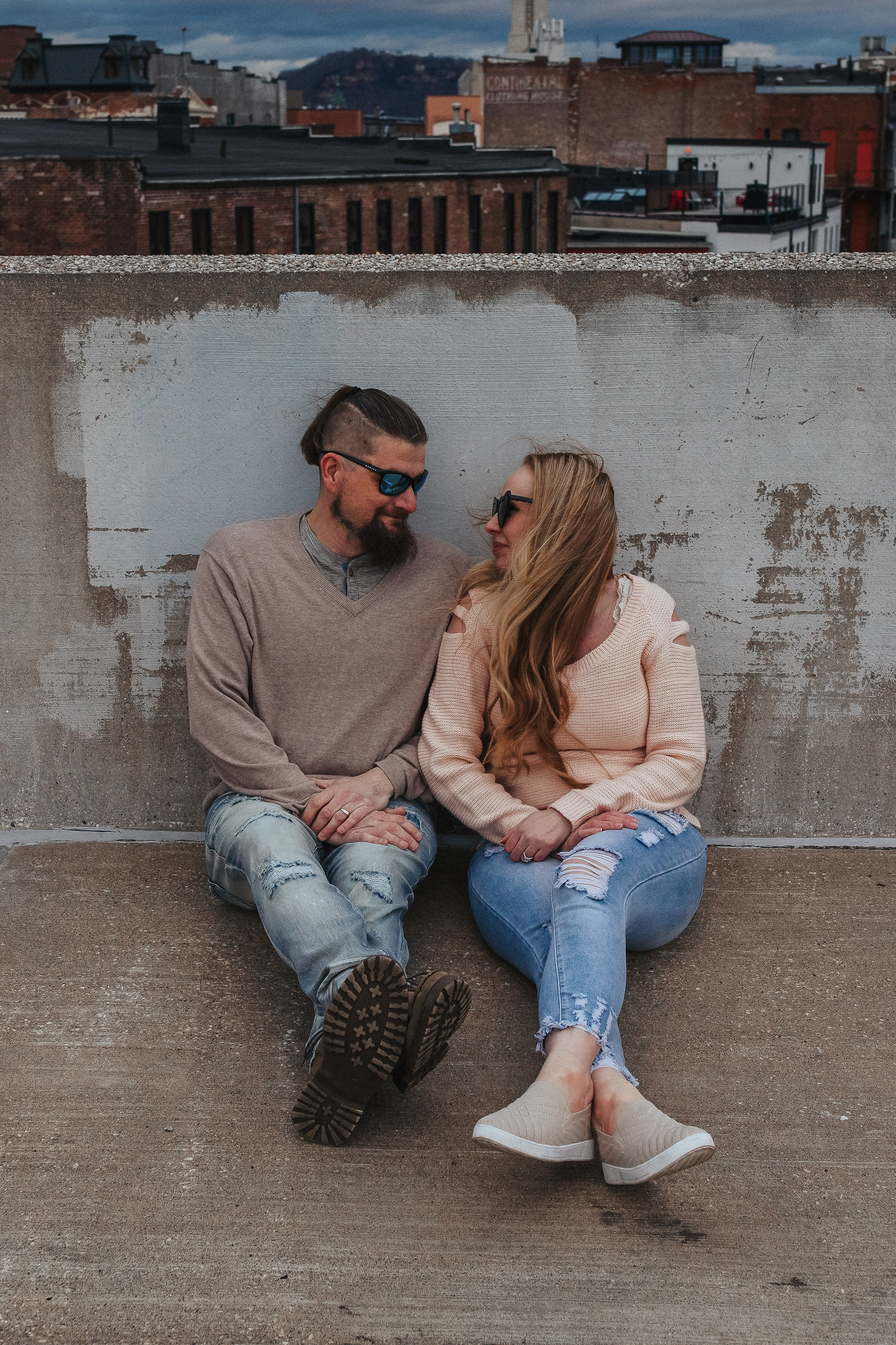Urban engagement session in downtown La Crosse Wisconsin on a parking ramp with city skyline